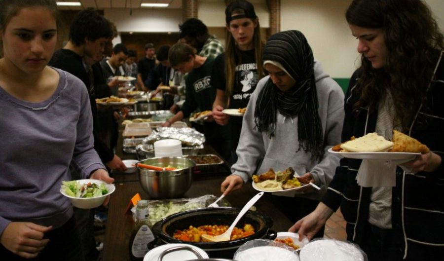 After the fast feast: Seniors Elsa Neal (right) and Jessica Jost (left) join the Muslim Student Union in its annual Fast-a-thon feast. The feast was for anyone who had fasted with MSU that day.  