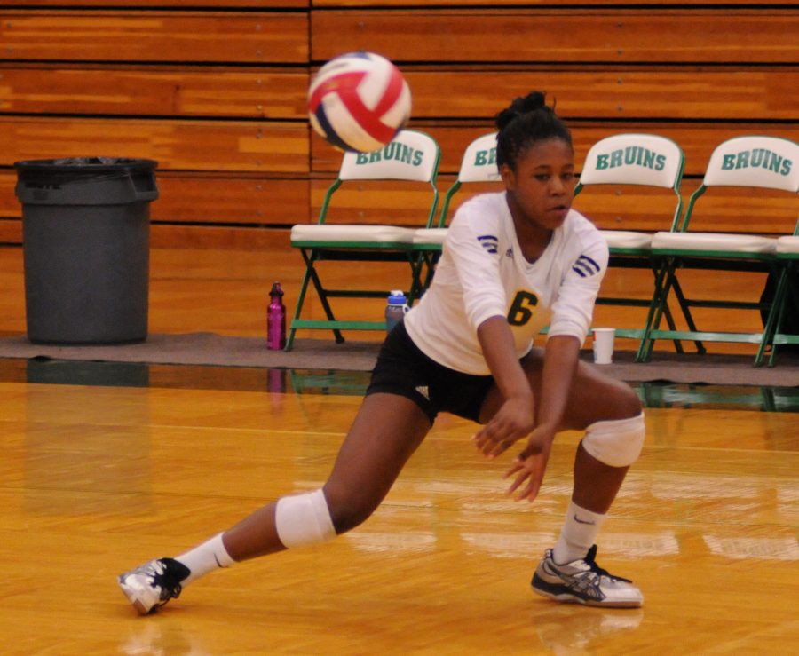 Yonne Nasimiyu, senior, lunges to save the ball to continue the the volley for a score. Photo by Patrick Smith