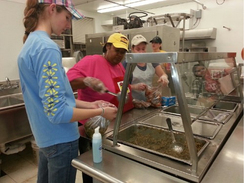 Volunteers at  RB elementary tediously prepare for the chicken barbeque held Saturday evening. 