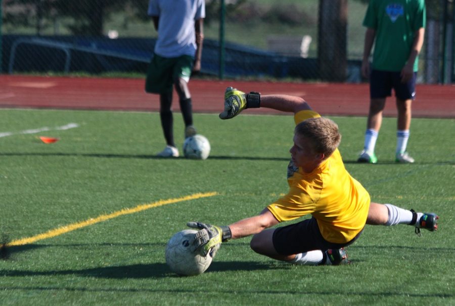 Goalkeeper Greg Kelly dives for a shot at a practice Sept. 12. Photo by Asa Lory