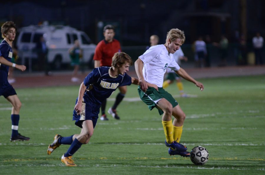 Senior Kyle Tonnies, defender, keeps the ball away from Helias during their match Oct. 1. Photo by Patrick Smith