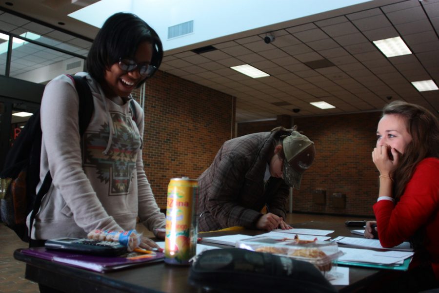 Senior Emily Thomas laughs with soon to be registered voters in the main commons this morning. Photo by Asa Lory