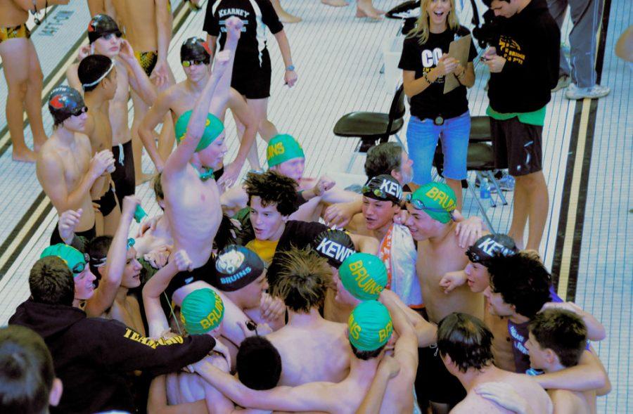 The+boys+swimming+and+diving+team+celebrate+the+qualification+time+of+one+of+RBHS+swimmers.+Photo+by+Erin+Kleekamp