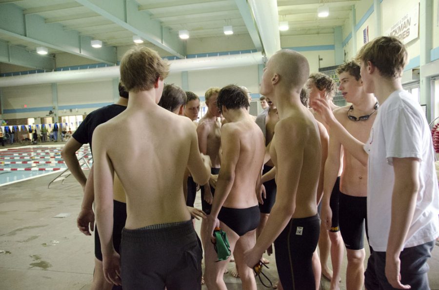 The boys swimming and diving team huddle together before practicing. Photo by Laurel Critchfield