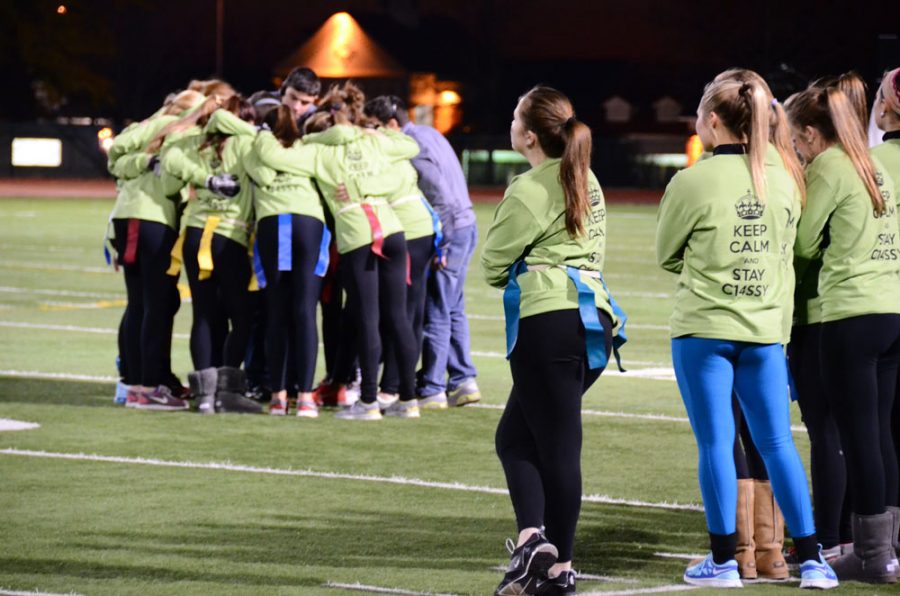 As their teammates on the side lines look up to the stadium lights, the rest of the Juniors huddle together for both tactic, and warmth, brain storming a game plan to beat the Sophomores. Photo by Elizabeth Upton