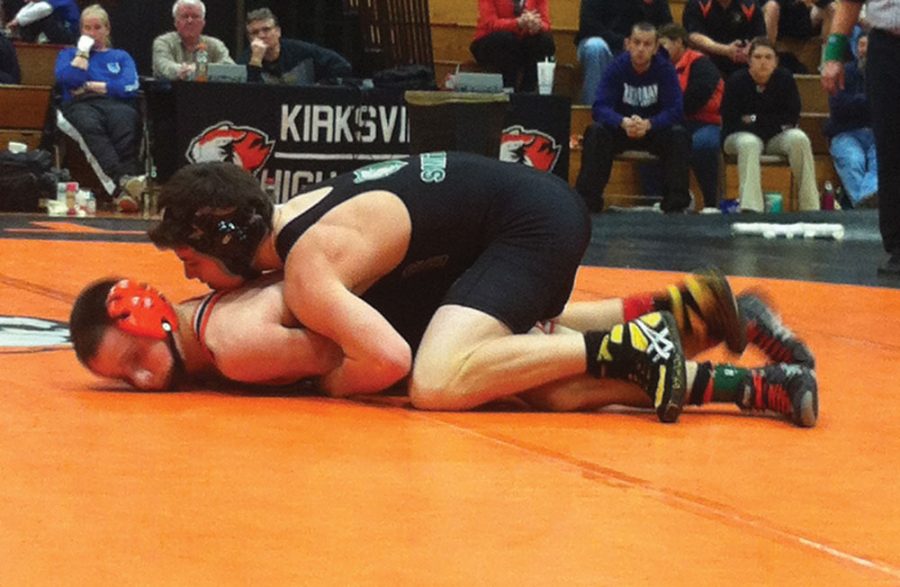  Junior Quinn Smith attempts to pin his Kirksville opponent Branden Beeler. Although the Bruins lost to the Tigers,  Smith won his match by major decision after 3 sets, 9-1.