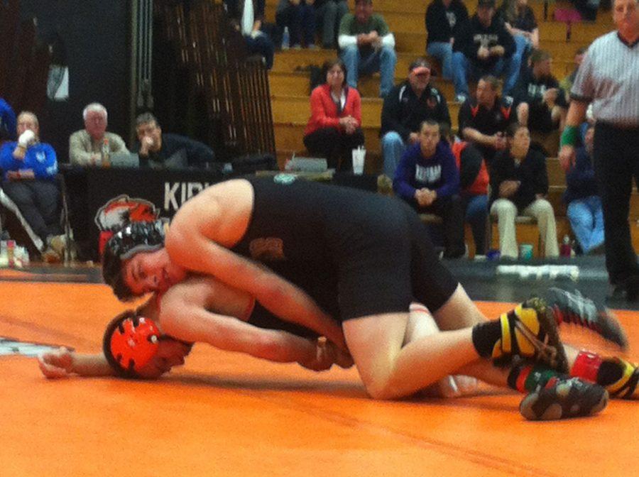 Junior Quinn Smith attempts to pin Kirksville opponent Branden Beeler Nov. 27. Smith won his match after three sets and won by major decision 9-1. Photo by Kaitlyn Marsh