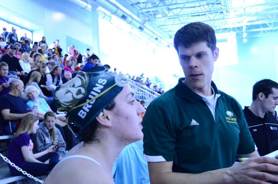Head coach Peter Willet talks to junior swimmer Ashley Shahan during the meet. Photo by Laurel Critchfield