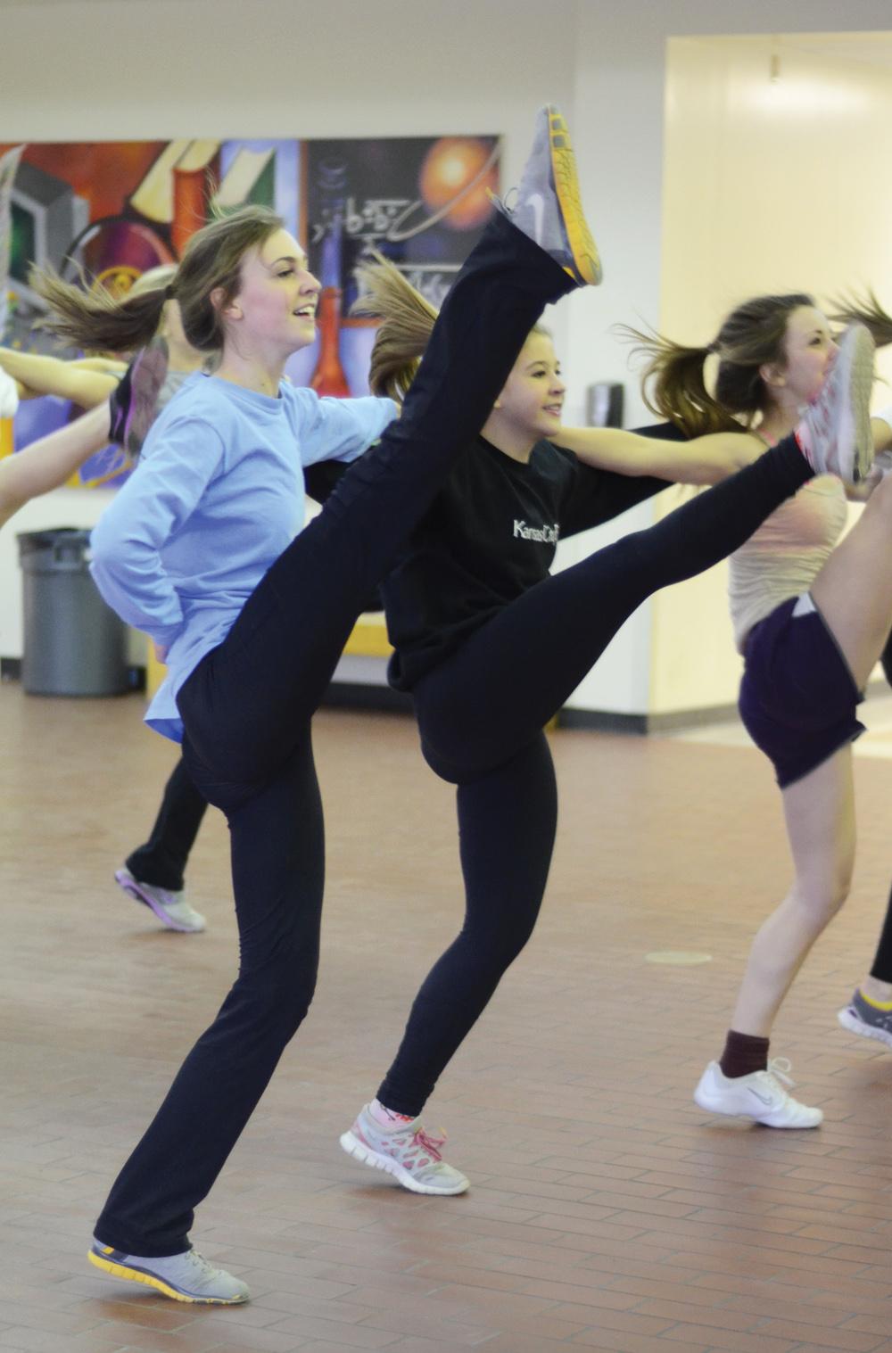 Senior Katherine Odom, junior Erin Concannon and freshman         Caitlynn Noltie practices their kickline for the upcoming state competition on Feb. 23. 