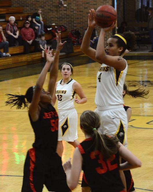 Sophomore Cierra Porter (4) out jumps Jeff City's players Kezia Martin (50) and Megan Foster (32) to score another shot for the Bruins. Porter scored 19 points for the team contributing to the dominating score of 72 to 21. Photo by Paige Kiehl.