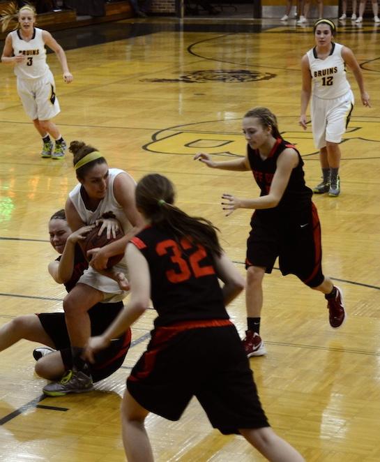 Holding on tightly to the ball, Audrey Holt (13) and Megan Foster (32) and two Jeff City players make to grab the ball Jan. 19. With the help of Sophie Cunningham (3) and Laurie Frew (12), Holt was able to keep possession of the ball and pass it to an open teammate. 
