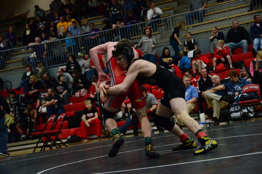 A Jefferson City Jay in the 126 weight class tries to score a point on an escape against opponent, junior Quinn Smith.