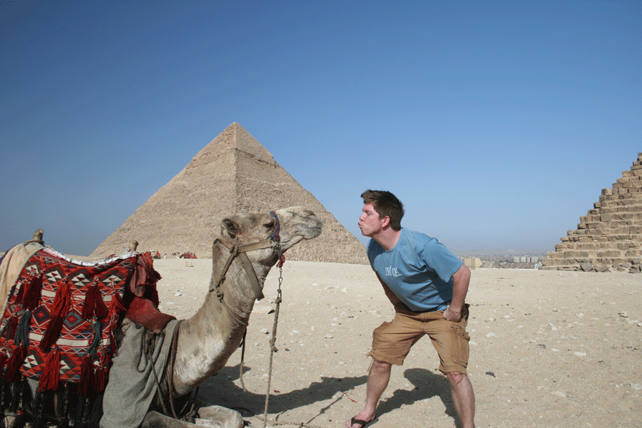 Ware and camel pucker up in front of ancient pyramids while visiting Cairo, Egypt.