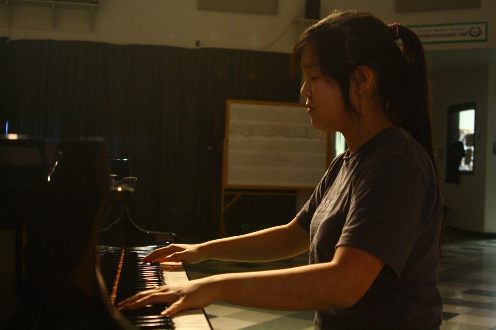 Junior Esther Liu uses the grand piano in the RBHS choir room to perform a song from memory in the quiet atmosphere of the area, when the bustle of show choir rehearsal has ended. An avid musician, Liu dedicates 45 minutes of her time to practice piano every day.