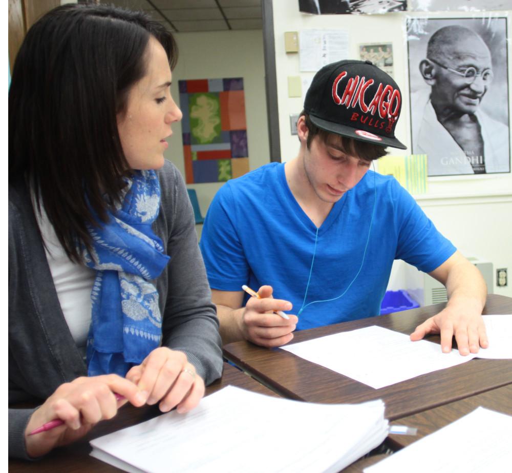 Mathematics teacher Amanda Dablemont assists junior Tim Stewart on a worksheet. She works with him one-on-one to solve a problem. Photo by Luke Wyrick