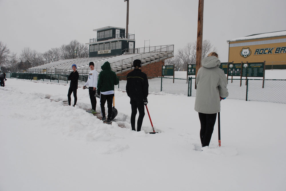 Digging deep: Members of RBHS track team shovel the blanket of snow that covered the track outside the school. Photo provided by Annette Schulte