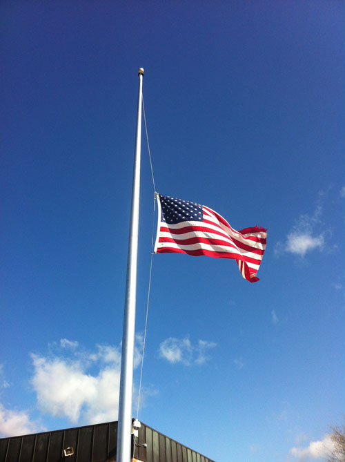 The flag waves at half staff. Photo by Jacqueline LeBlanc