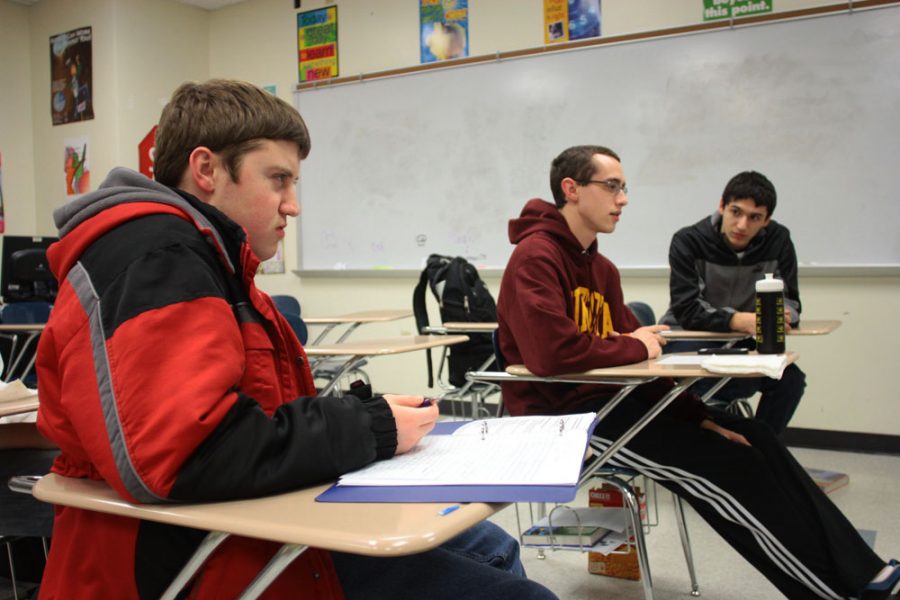 Seniors Jonathon Ackmann, Jacob Freyermuth and Dima Rozenblat practice Personal Finance vocabulary after school on Thursday. The team also includes Charles Shang (not pictured). Photo by Asa Lory