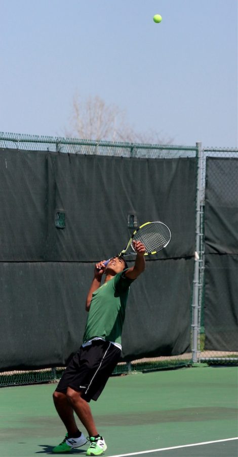 Sophomore+Rohit+Rao+begins+a+serve+at+yesterdays+Rock+Bridge+Boys+Tennis+meet+against+Park+Hill.+Photo+by+Asa+Lory