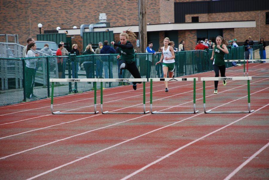 Senior Sienna Trice takes the lead during the 300 meter hurdles followed closely by senior Mallory Short. Trice received first place while Short placed third in the event May 4. Photo by Morgan Nuetzmann