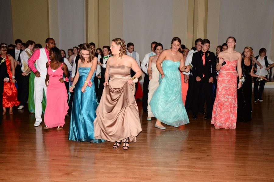 Prom participants line up for the Cupid Shuffle, trying to stay off of each others toes in the process. Donning their dresses and clutching their purses and phones, they all focus on performing the right moves.
Photo by Renata Williams.