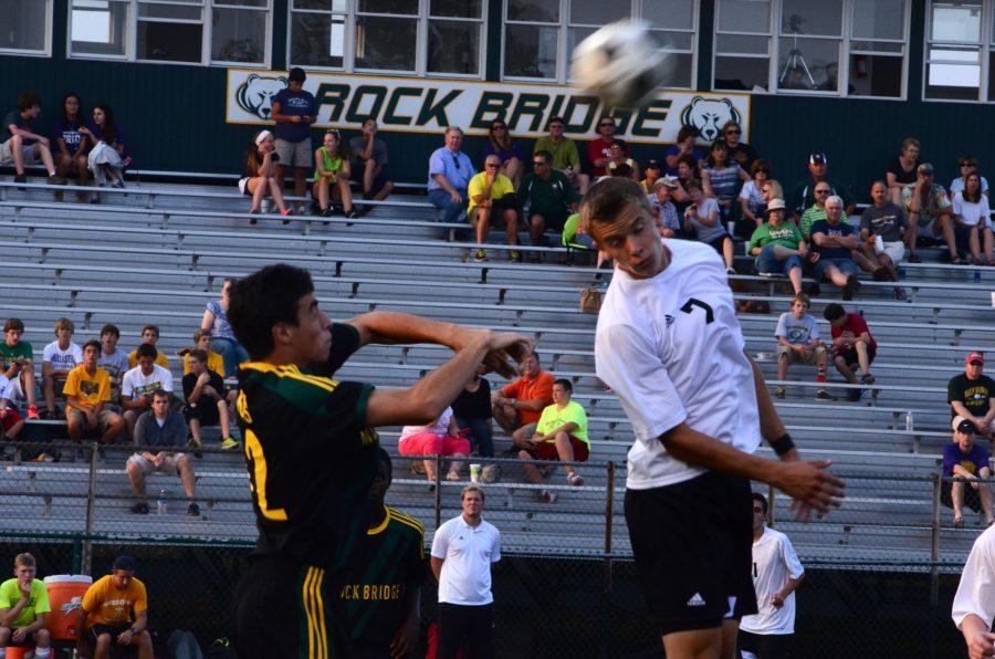 Senior Blake Hausman deflects the ball away from a Timberland rival during Rock Bridges second game at the Soccer Jamboree held at Rock Bridge last night.