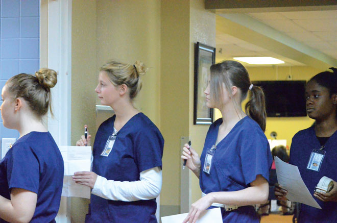 Getting connected: Students enrolled in the Professions in Healthcare course at the Columbia Area Career Center attend clinicals at Lenoir Woods, a local senior center. Those enrolled in the class learn the skills needed to take care of a variety of possible cases they may be presented in the profession.