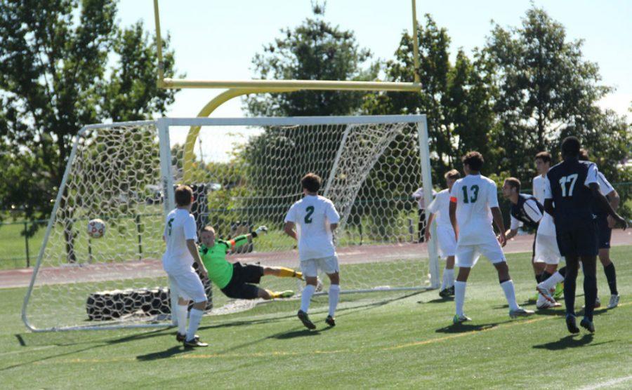 Senior Goalkeeper Greg Kelly dives to make a save against their opponents, Marquette High School which ended in a score of 2-1 RBHS. Photo by Justin Sutherland.