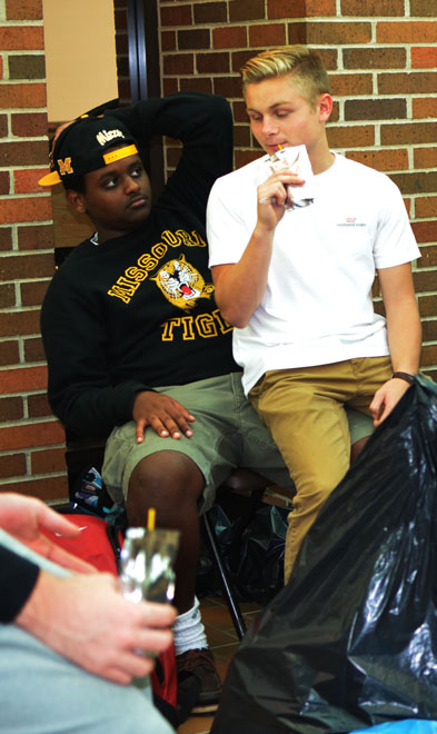 A job well done: Juniors Aaron Ghidey and Brendan McLaughlin relax after helping clean up trash around RBHS during the joint project.