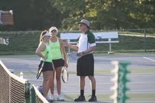 Coach Ben Loeb speaks with members of the girls tennis team during a match at Bethel Park.
