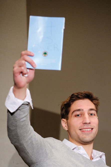 Ryan Ferguson holds up a sign reading, “It Is Over,” shown to him earlier by his attorney, Kathleen Zellner. 