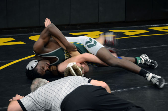 Ernest Dorema works to put his opponent in a submission hold and earned a point during this preliminary match. He ended up beating his opponent at the JV meet in Lebanon, Mo. this weekend while varsity competed in the Hickman tournament. Photo by Jazzmine Matthews