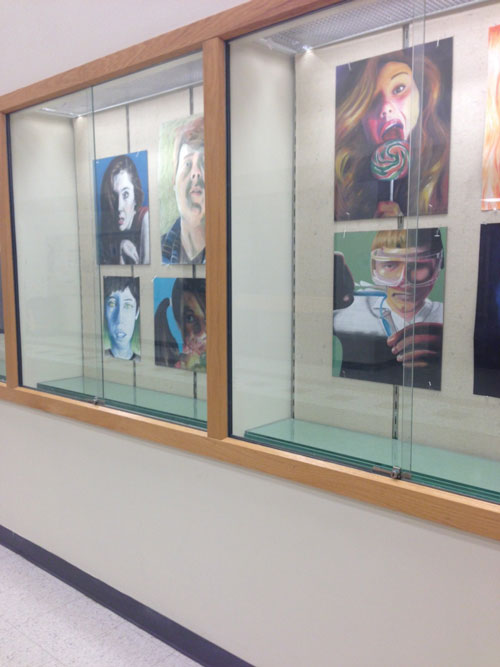 Showcasing talent: RBHS students’ art hangs in a display case near the main office. Some of their art will be shown on Sunday. Photo by Sophie Whyte