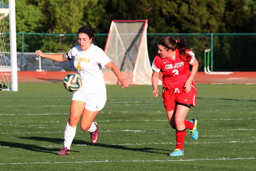 Staying ahead of her opponent, senior Laurie Frew moves down the field. Bruins lost to Cor Jesu 1-3 during the Varsity girls soccer game, May 9.  Photo by Amy Blevins