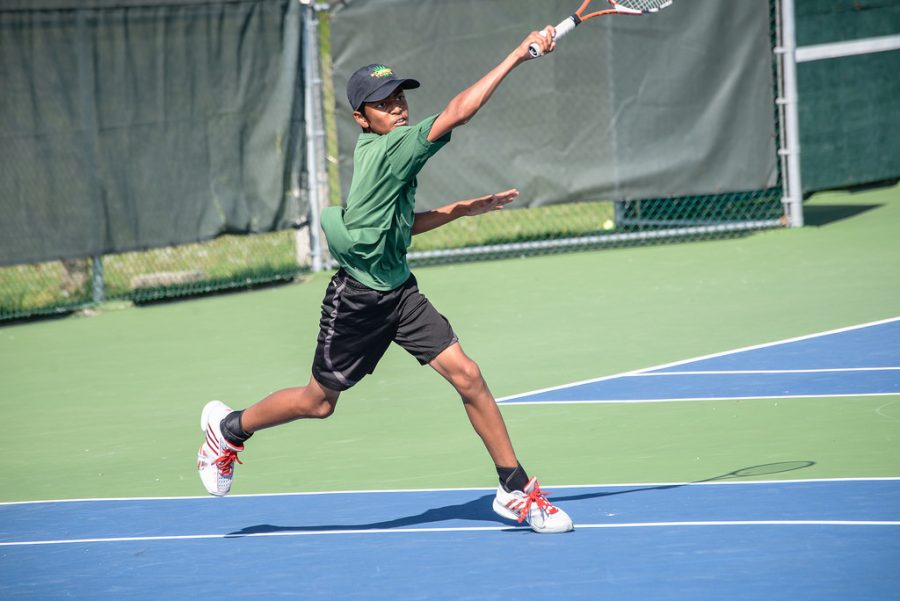 Freshman Keerthivaas Premkumar hits a forehand during a meet against Hickman.
Photo by Catherine Howser