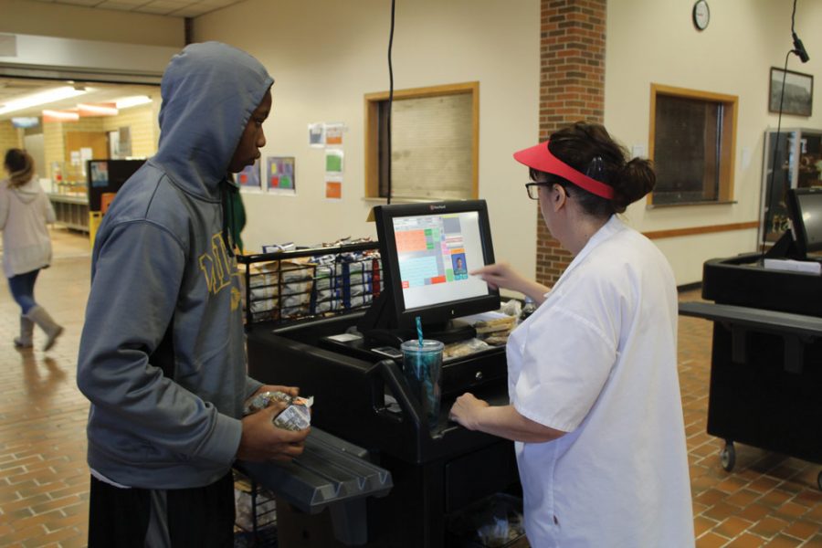 Censored food: Freshman Marqtrel Harris stands in line to buy lunch. The new USDA regulations on the healthiness of all food items have caused the district to lose money to the food budget, along with more food waste. Photo by Devesh Kumar
