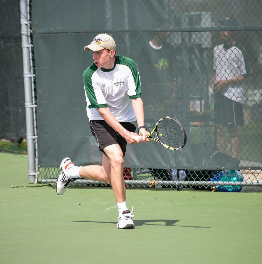 Junior+Brian+Baker+runs+to+hit+a+backhand+against+his+opponent%2C+Jack+OConnor%2C+from+Rockhurst+High+School.+RBHS+ended+up+losing+the+match+9-0+against+their+rivals.%0A