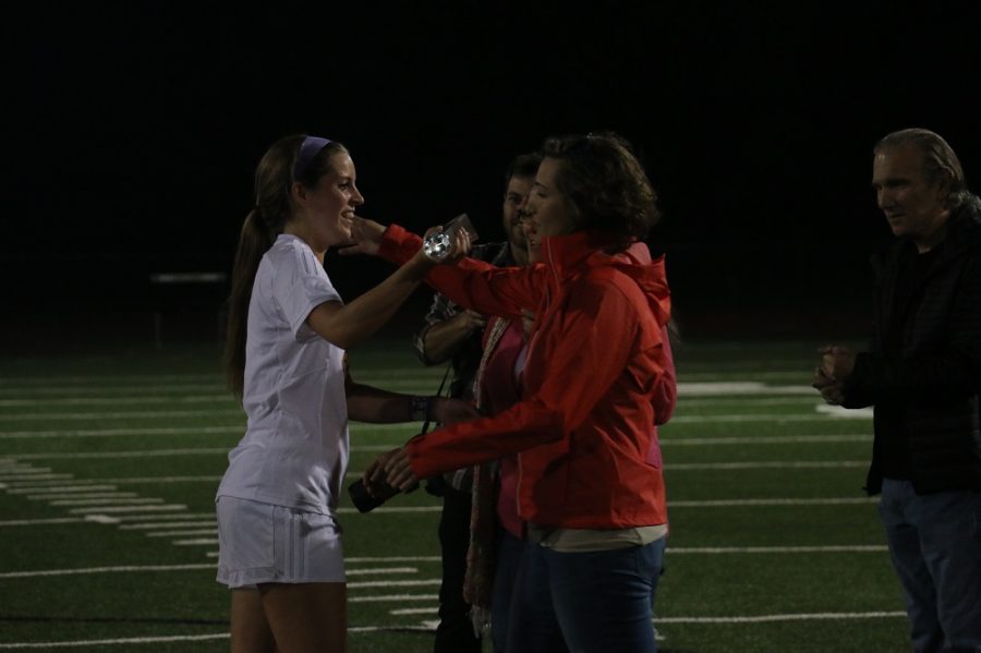 Senior Sydney Griggs embraces and thanks the family of Anna Alioto. The game was dedicated to the memory of Anna Alioto, a former Rock Bridge soccer player who passed away during her freshmen year of college.