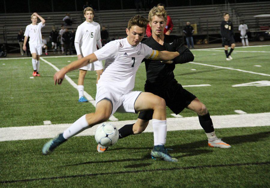 Senior Jonah Lage defends the ball and prepares to pass it to a teammate.