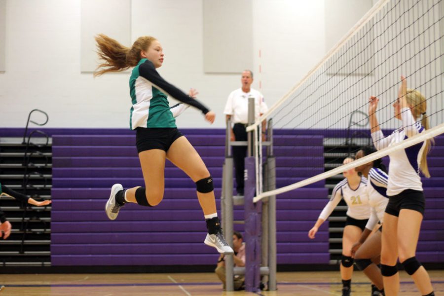 Freshman Peyton Moore successfully spikes and scores a point for Rock Bridge.