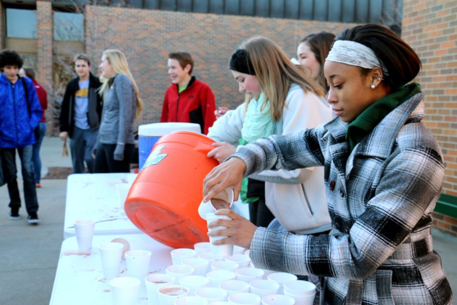 Junior RonTayza Hill pours the remaining hot chocolate into cups to hand out to students. Last years hot chocolooza involved unintentional frozen cans of whipped cream and sparse hot water. photo by Mariah Journey