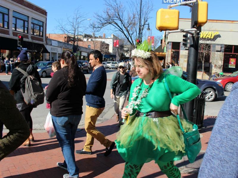 A green-clothing clad Q line queen makes her way to her next movie venue.