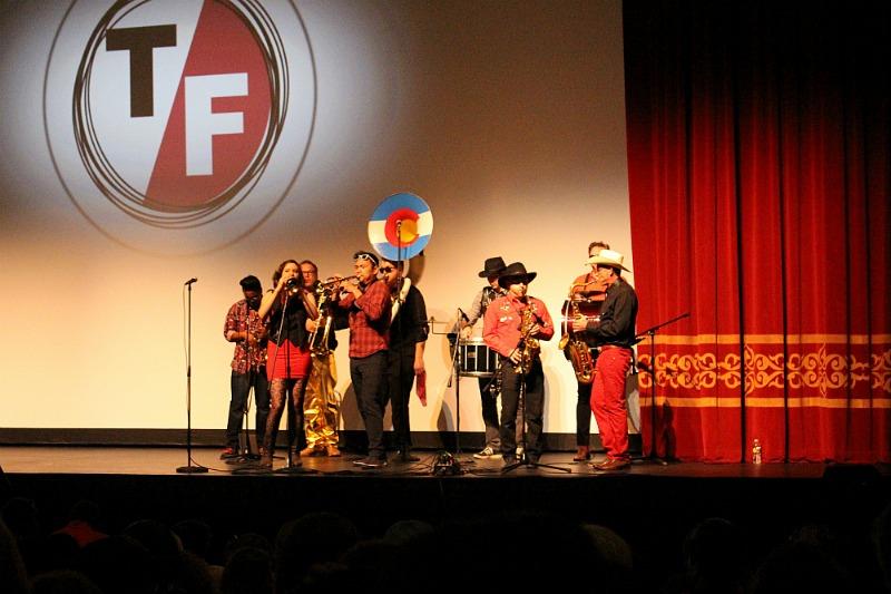 A band plays as the audience anxiously awaits the film "Sonita". The ten member band came from Colorado to perform at the fest for free, and later passed a tip hat throughout the crowd.