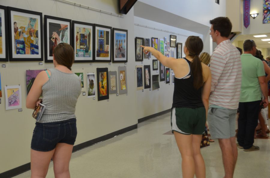 Students admire art at the Depth art show.