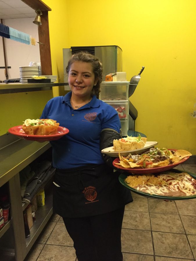 Juggling tasks: Junior Brenda Herdandez, an employee at La Tolteca, waits tables at the Jefferson City location. She said her favorite part of working there is spending time with her family.