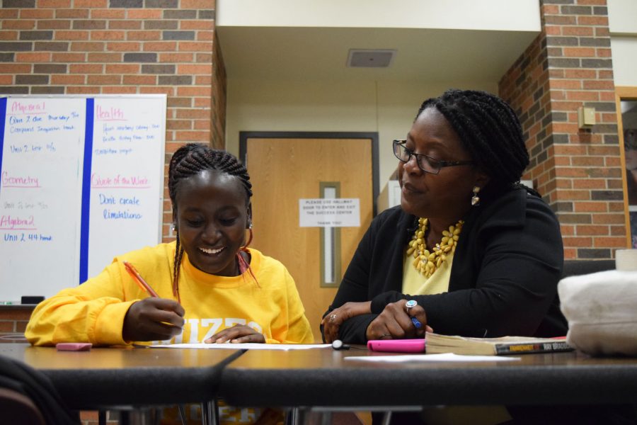 Mrs. Debra Perry helps Freshman Purity Kagiri with her essay in the success center. Photo by Abby Blitz
