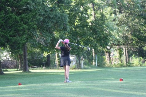 Senior Haley Diel watches her ball closely after her drive on the tee box. Photo by Anna Ostempowski
