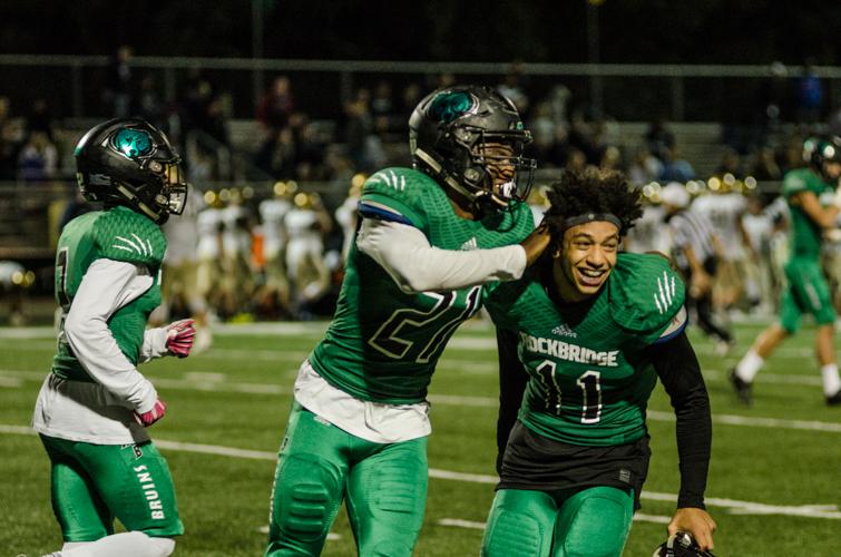Seniors Randy James, #21, and Isaiah Patrick, #11, celebrate immediately after winning the homecoming game against the Helias Crusaders on Sept. 30. The Bruins surprised the audience with a 46-33 upset victory, marking their second win of the season. Photo by Yousuf El-Jayyousi