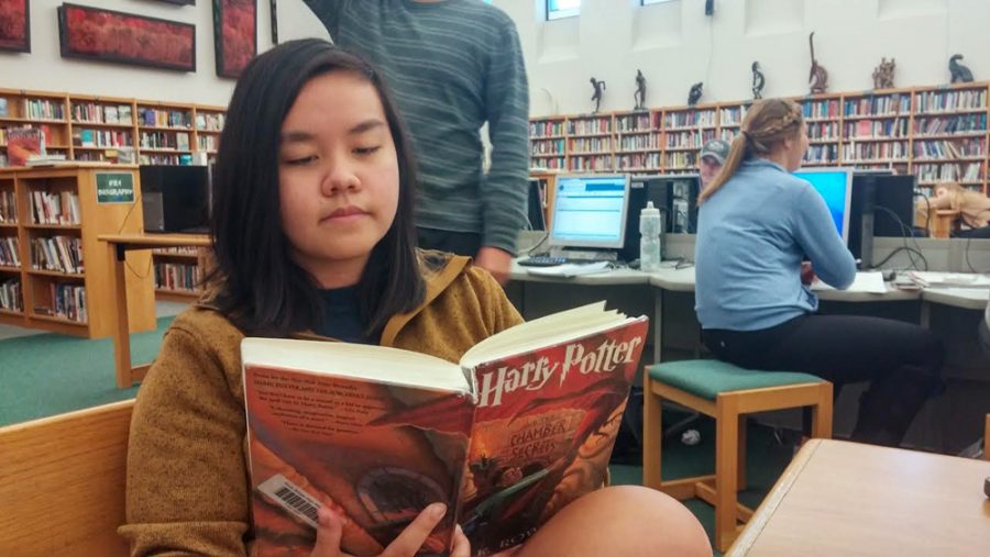 Junior+Billie+Huang%2C+an+avid+fan+of+the+series%2C+reads+a+Harry+Potter+novel+in+the+school+library.+Photo+by+Rochita+Ghosh.