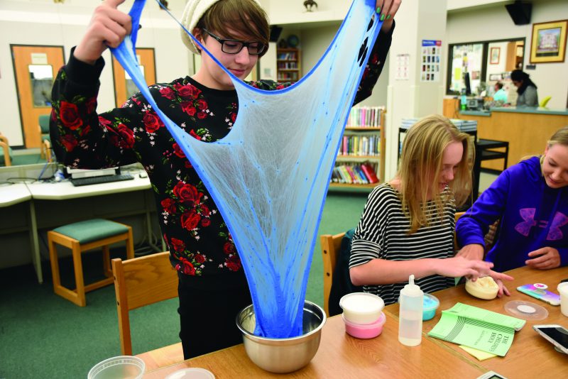 Junior Bailey Long experiments with various slime solutions.
 Long is just one of many slime sellers on Etsy.  Photo by Camryn DeVore